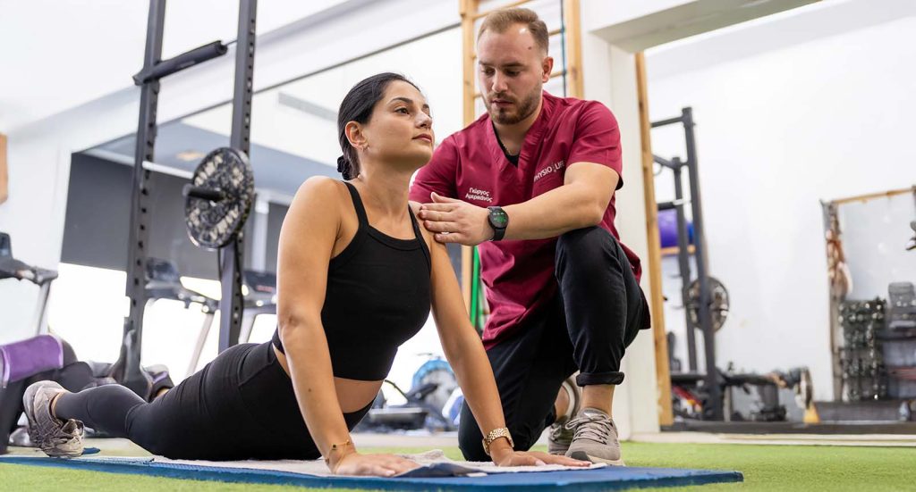 Physiolife physiotherapist guiding a stretching exercise